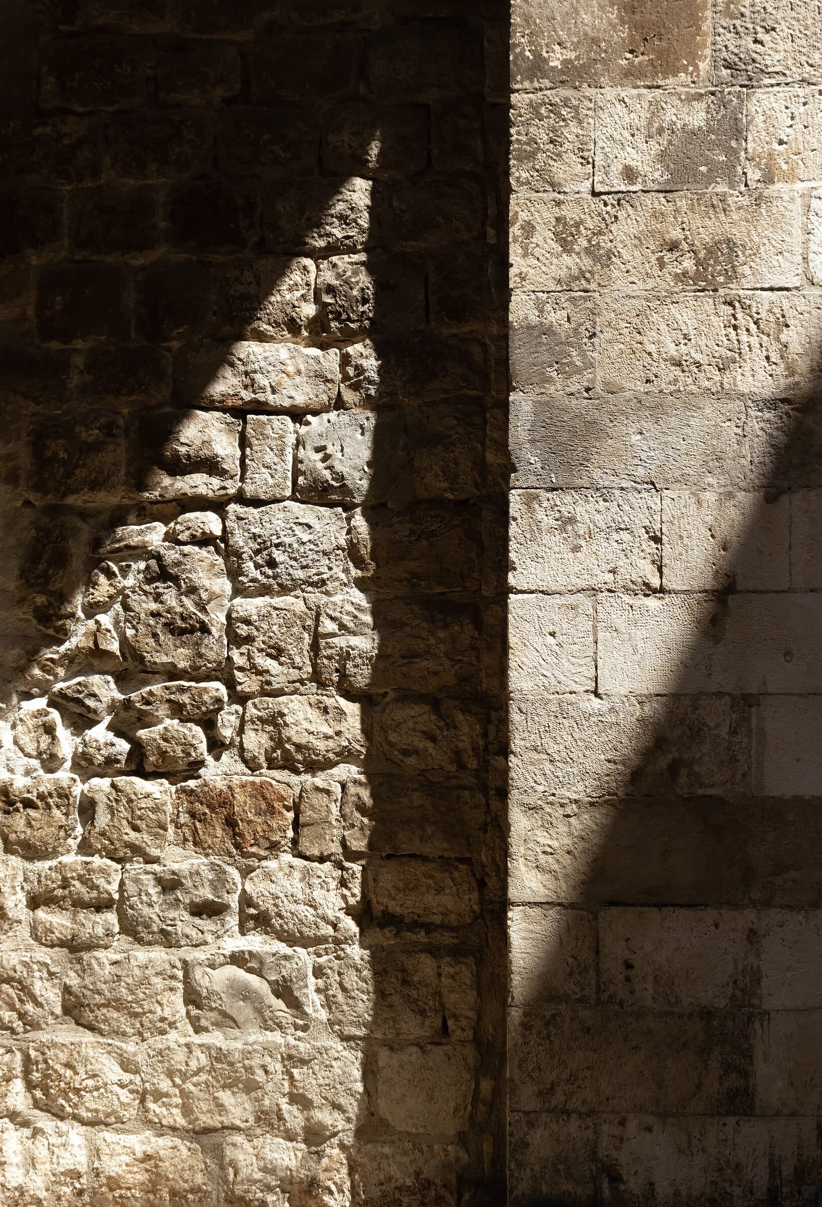 Morning light falling across the corner of an old stone wall